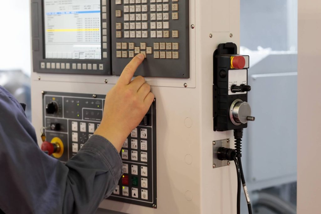 Worker effectively trying to minimize production downtime in cnc operations